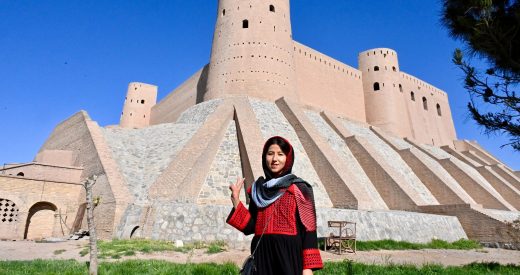 Fatima, female tour guide in Afghanistan, standing in front of Herat Citadel in Herat